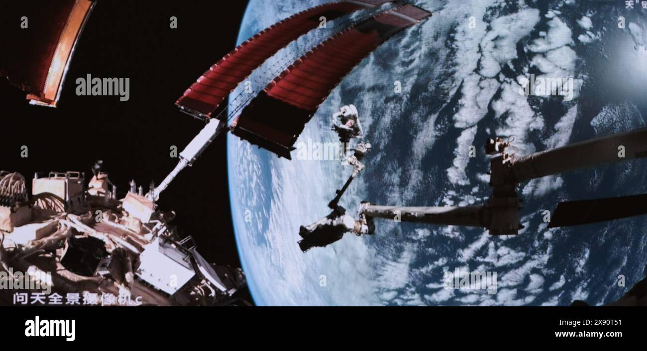 Beijing, China. 28th May, 2024. This screen image captured at Beijing Aerospace Control Center on May 28, 2024 shows Shenzhou-18 astronaut Ye Guangfu performing extravehicular activities assisted by the robotic arm of the space station. The Shenzhou-18 crew members on board China's orbiting space station completed their first spacewalk on Tuesday, according to the China Manned Space Agency. Credit: Li Jie/Xinhua/Alamy Live News Stock Photo