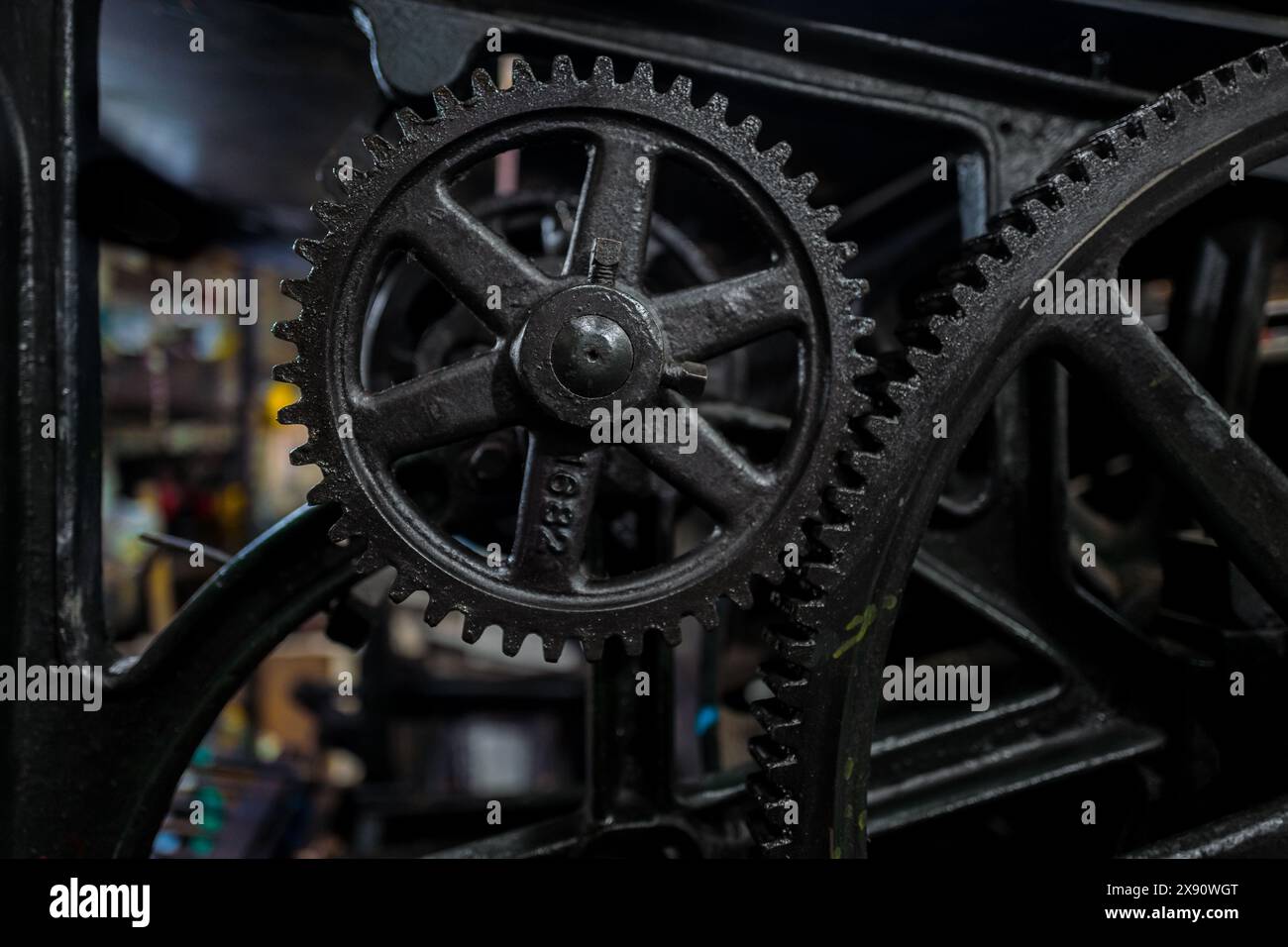 A detail view of the gear train of the historical letterpress machine at a printing workshop in Cali, Colombia, on March 5, 2024. Stock Photo