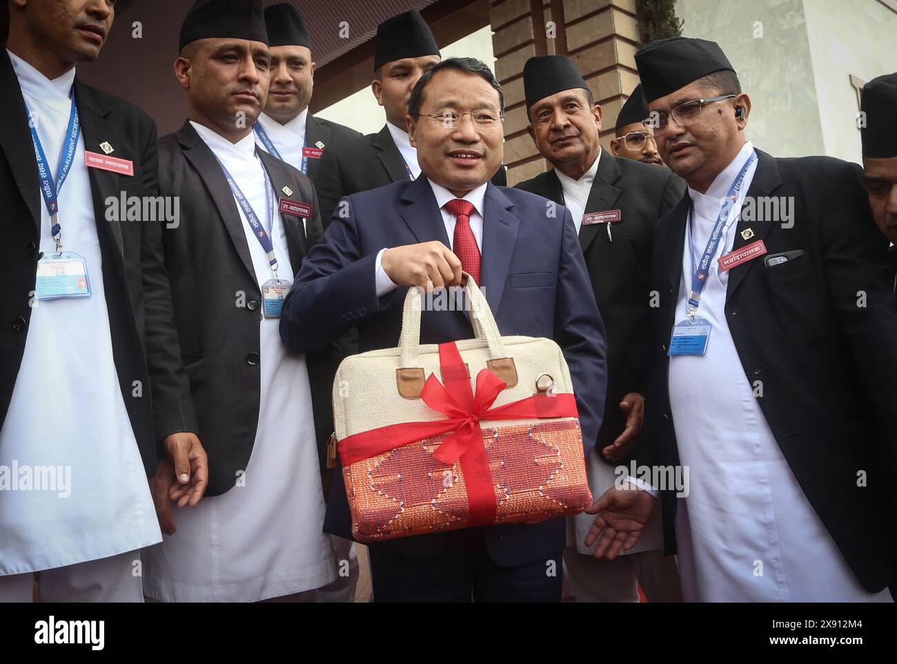 May 28, 2024: Nepali Finance Minister Barsha Man Pun (C) shows a traditonal briefcase containing the budget speech of the fiscal year 2024-25 before entering the parliament in Kathmandu, Nepal, May 29, 2024. The government unveiled its annual budget of 1.86 trillion for the fiscal year 2024-25 at the joint session of the federal parliament on Tuesday. (Credit Image: © Sunil Sharma/ZUMA Press Wire) EDITORIAL USAGE ONLY! Not for Commercial USAGE! Stock Photo