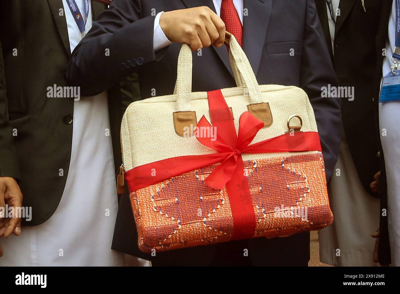 May 28, 2024: Nepali Finance Minister Barsha Man Pun holds a traditonal briefcase containing the budget speech of the fiscal year 2024-25 before entering the parliament in Kathmandu, Nepal, May 29, 2024. The government unveiled its annual budget of 1.86 trillion for the fiscal year 2024-25 at the joint session of the federal parliament on Tuesday. (Credit Image: © Sunil Sharma/ZUMA Press Wire) EDITORIAL USAGE ONLY! Not for Commercial USAGE! Stock Photo
