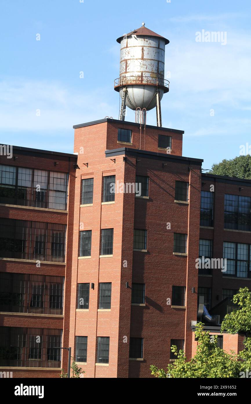 Virginia, U.S.A. Repurposed industrial building with water tank on the roof at Charlottesville Woolen Mills. Stock Photo