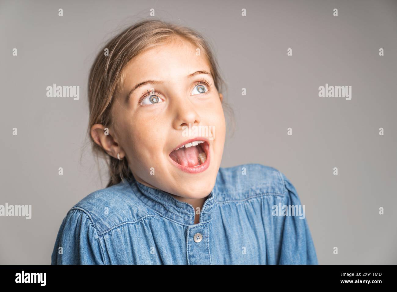 stylish little girl portrait in the studio look suprise Stock Photo - Alamy