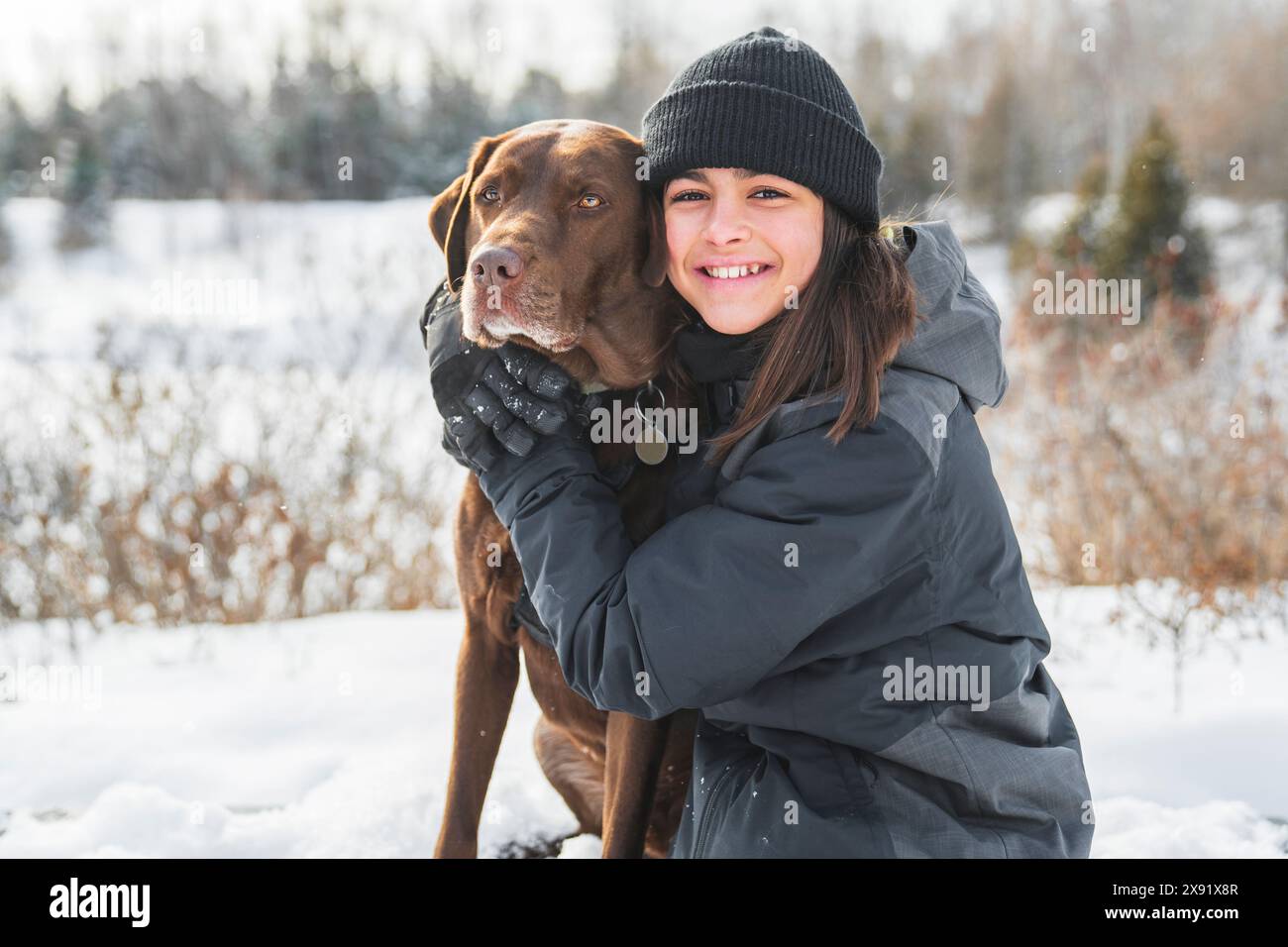 Portrait of little girl with labrador dog in winter season Stock Photo