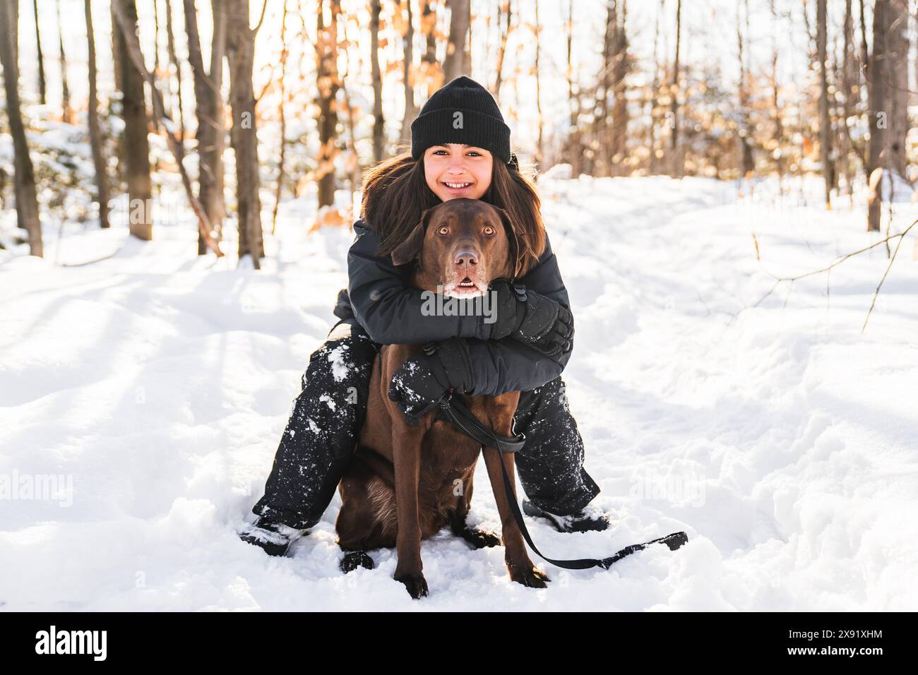Portrait of little girl with labrador dog in winter season Stock Photo