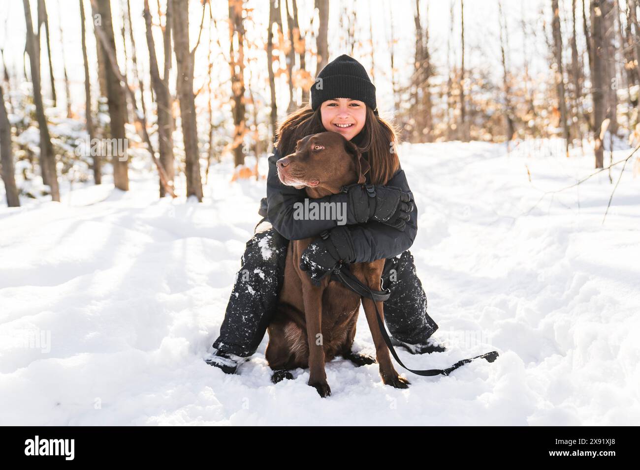 Portrait of little girl with labrador dog in winter season Stock Photo