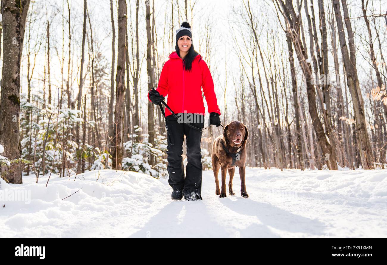 Portrait of a woman with labrador dog in winter season Stock Photo