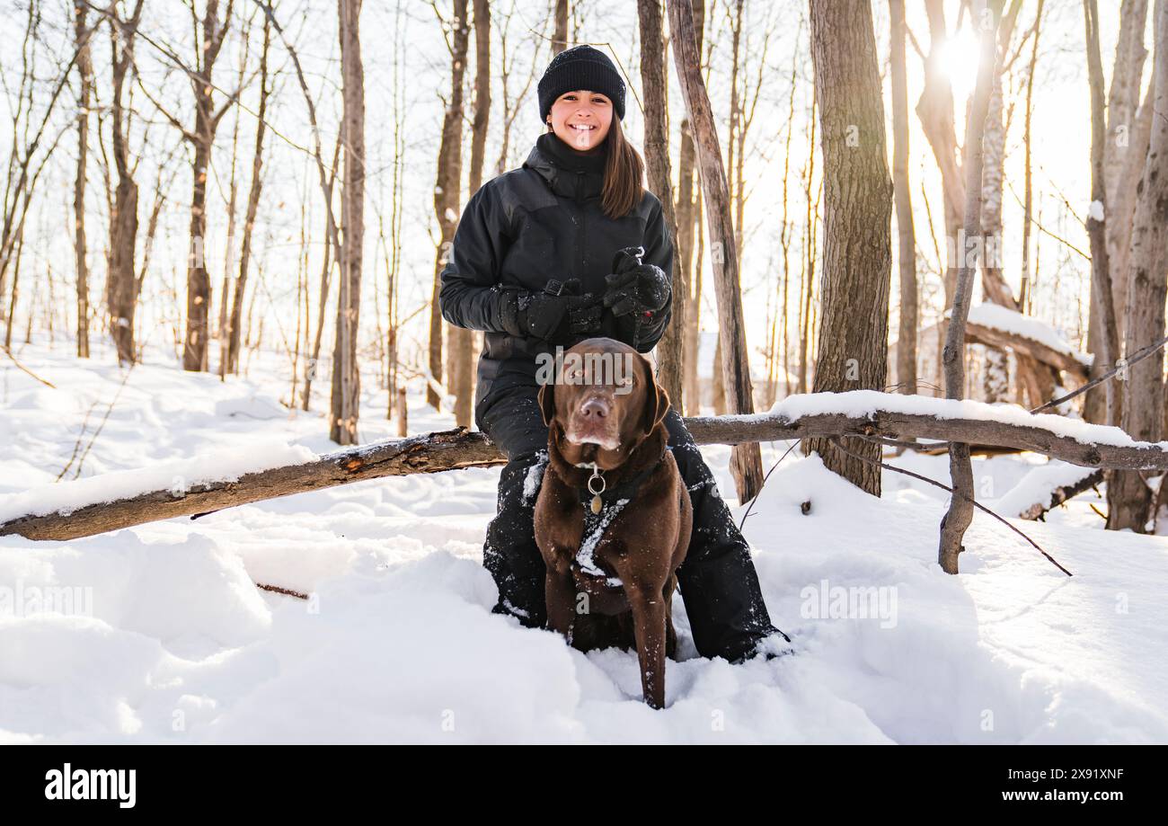 Portrait of little girl with labrador dog in winter season Stock Photo