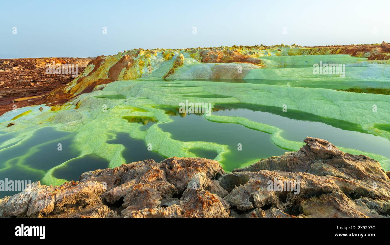 Colorful green volcanic lake terraces and yellow sulphur minerals, Danakil Depression desert, Afar region, Ethiopia Stock Photo