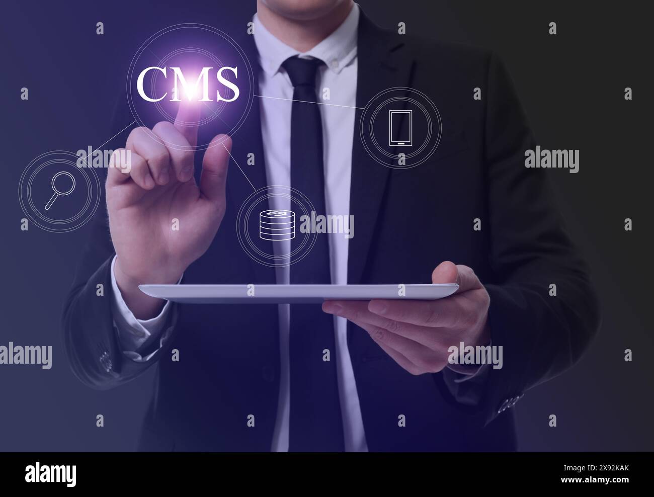 CMS. Man with tablet using virtual screen, closeup. Scheme with icons on dark background Stock Photo