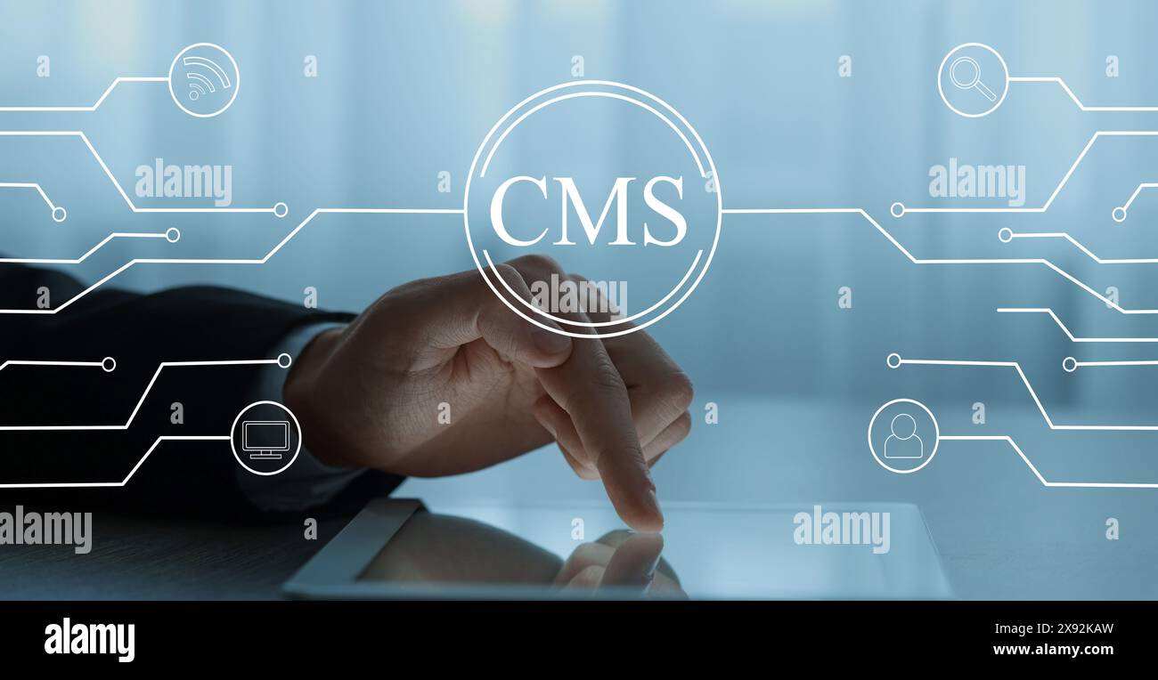 CMS. Man using tablet at table, closeup. Scheme with icons over device Stock Photo