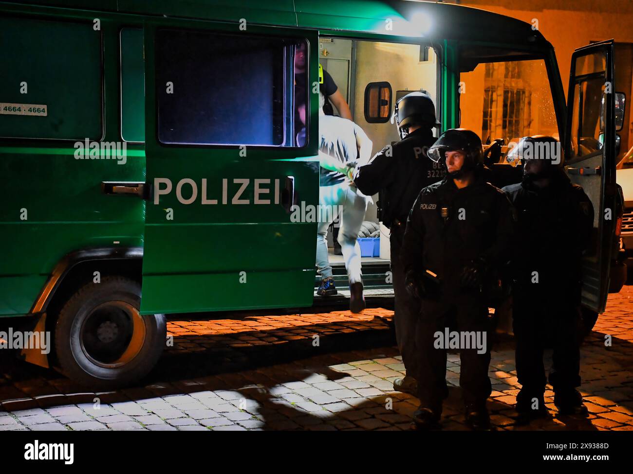 Berlin, Germany. 28th May, 2024. Police officers lead a man who was briefly arrested into a police car not far from Sonnenallee in Neukölln. In Sonnenallee, there were sometimes violent clashes between people chanting 'Freedom for Palestine'. Credit: Paul Zinken/dpa/Alamy Live News Stock Photo