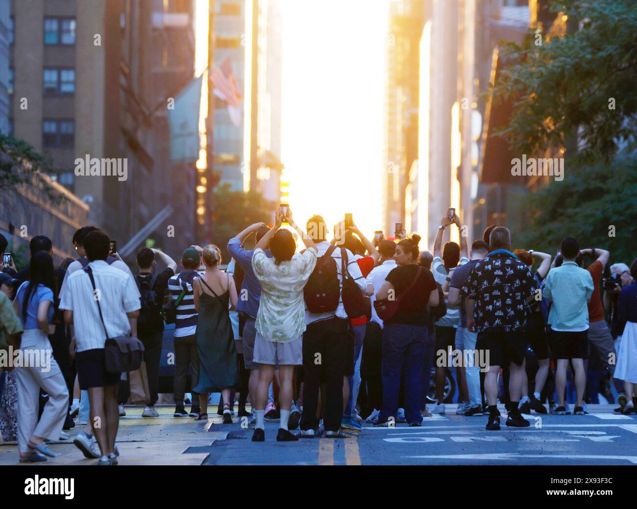 New York, United States. 28th May, 2024. Revelers holding cameras and