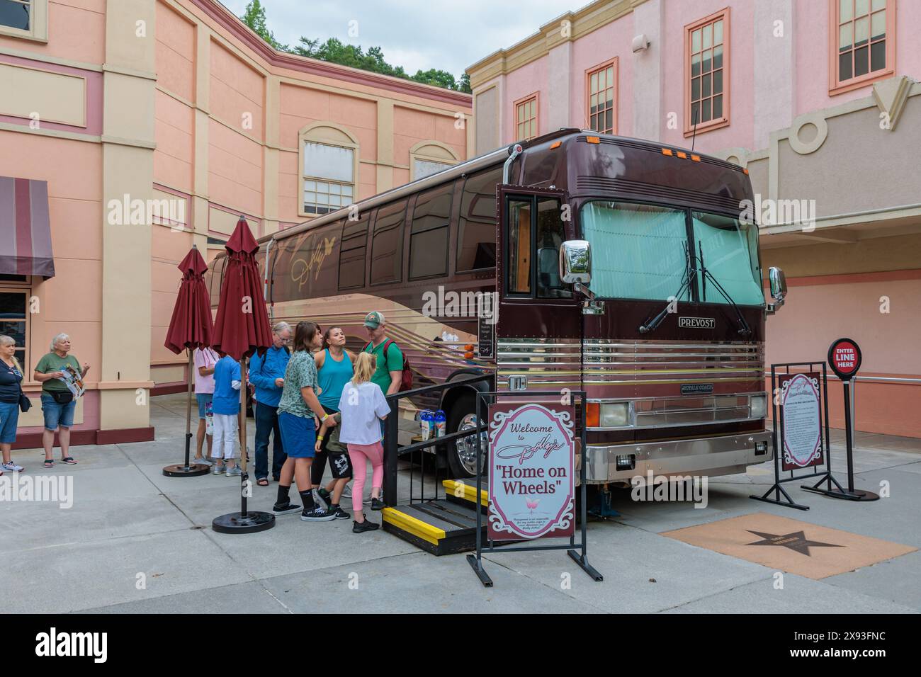 Guests line up to walk through Dolly's Home on Wheels tour bus at the
