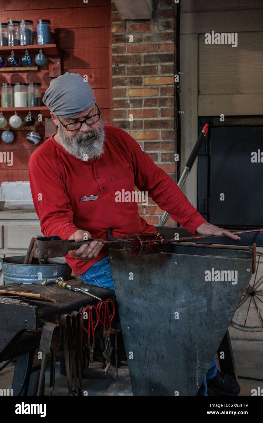 Glass blower demonstrates the art of blowing glass at the Dollywood