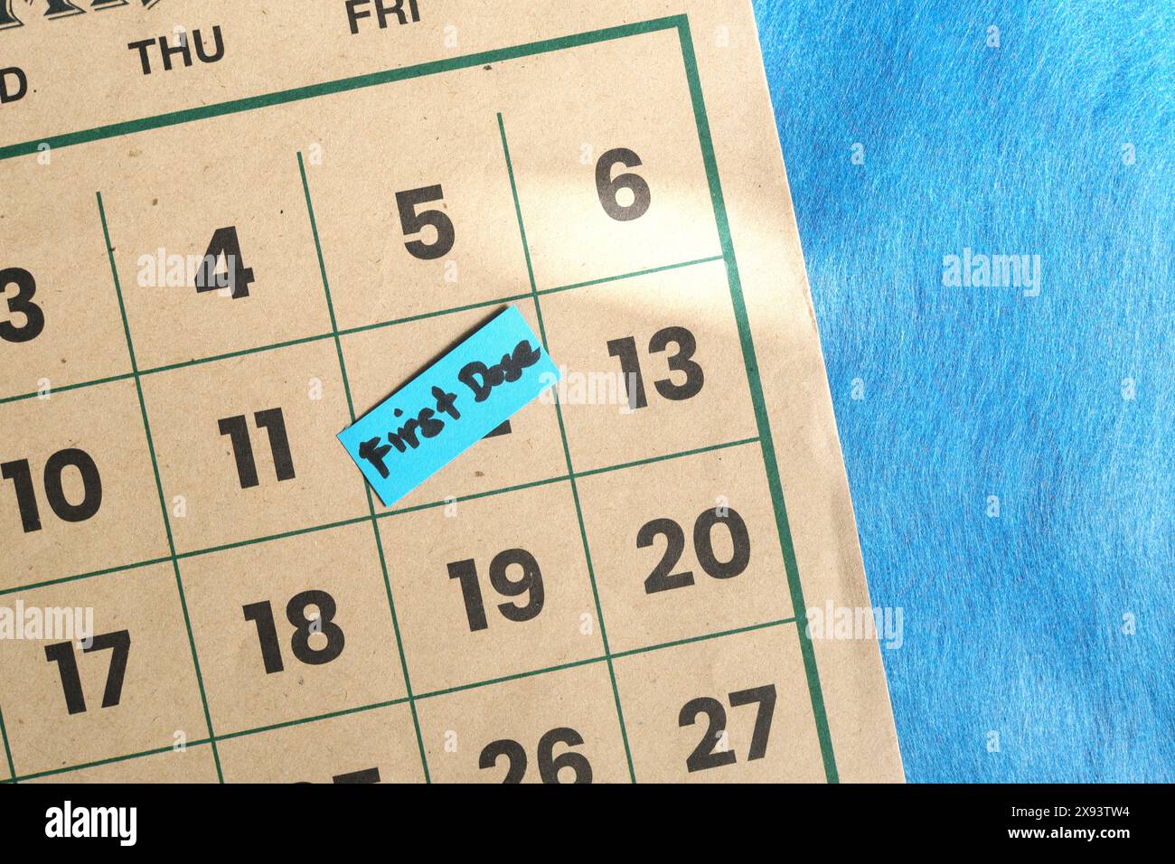 First dose vaccine shot schedule concept. Written reminder note on calendar. Stock Photo