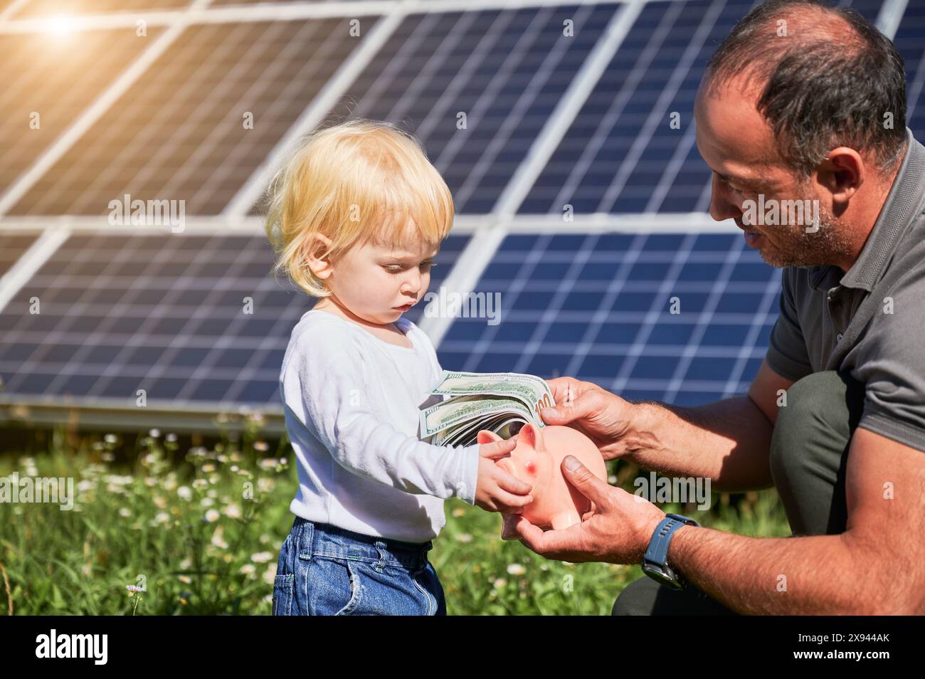 Father and son putting coin piggy bank hi-res stock photography and ...