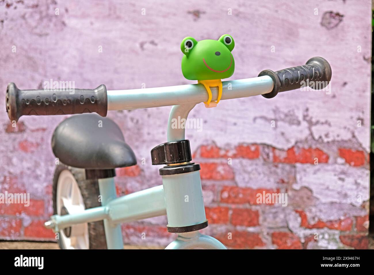 Rubber frog accessory on the balance bike handle Stock Photo Alamy