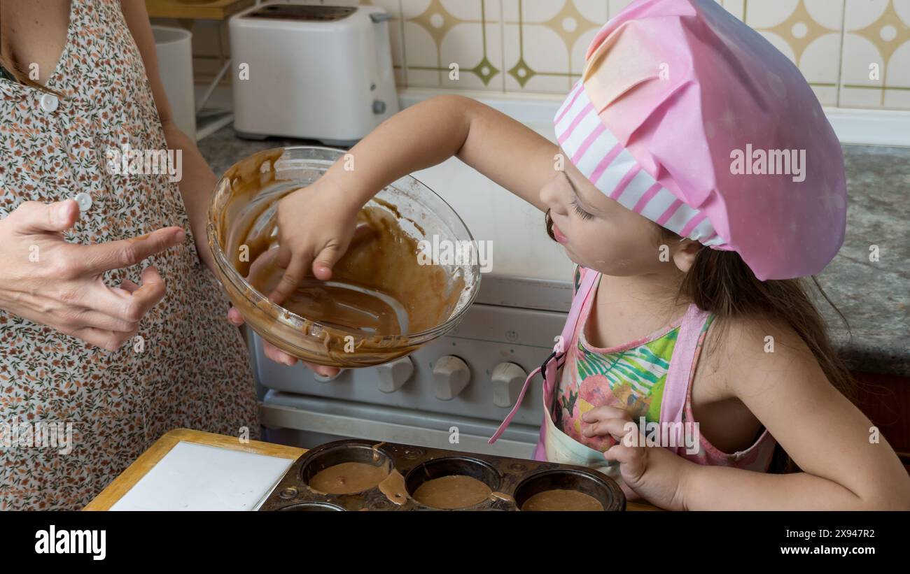 a girl dressed as a cook enjoying an afternoon of cooking with her ...