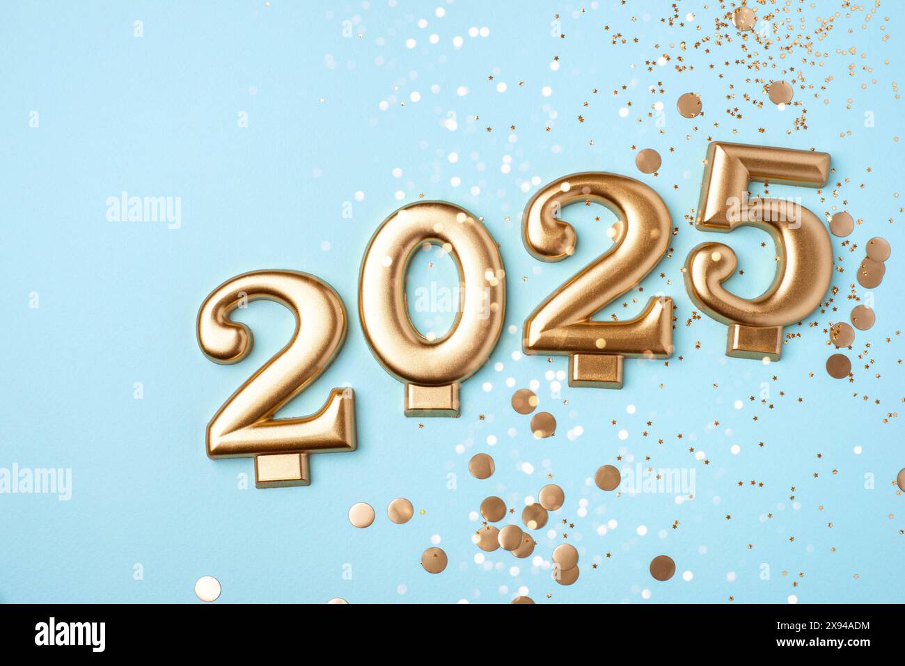 Golden 2025 on a blue color background with confetti and bokeh lights