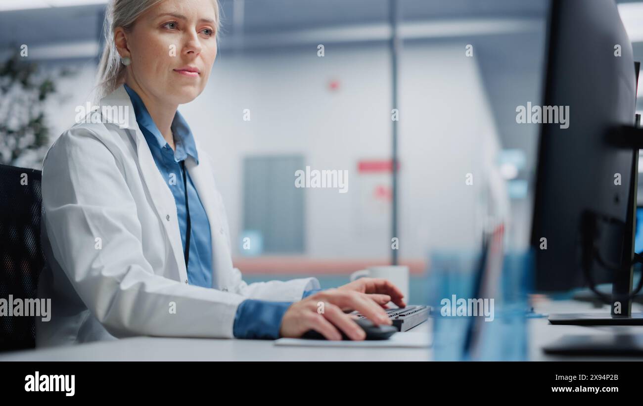 Medical Hospital Research Lab: Female Neurosurgeon Using Computer with ...