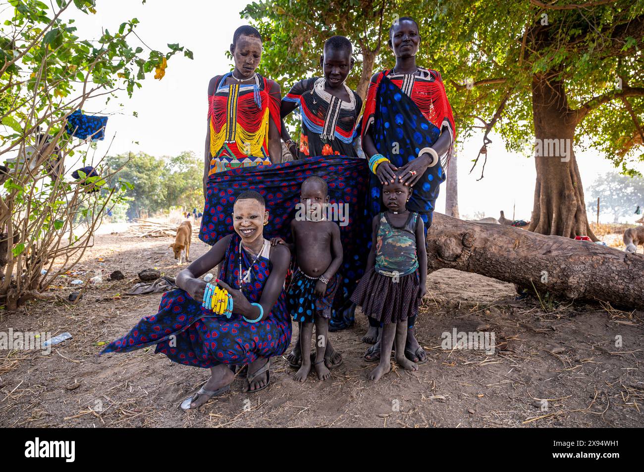 Pretty Mundari girls in traditional dresses posing with their children, Mundari tribe, South Sudan, Africa Stock Photo