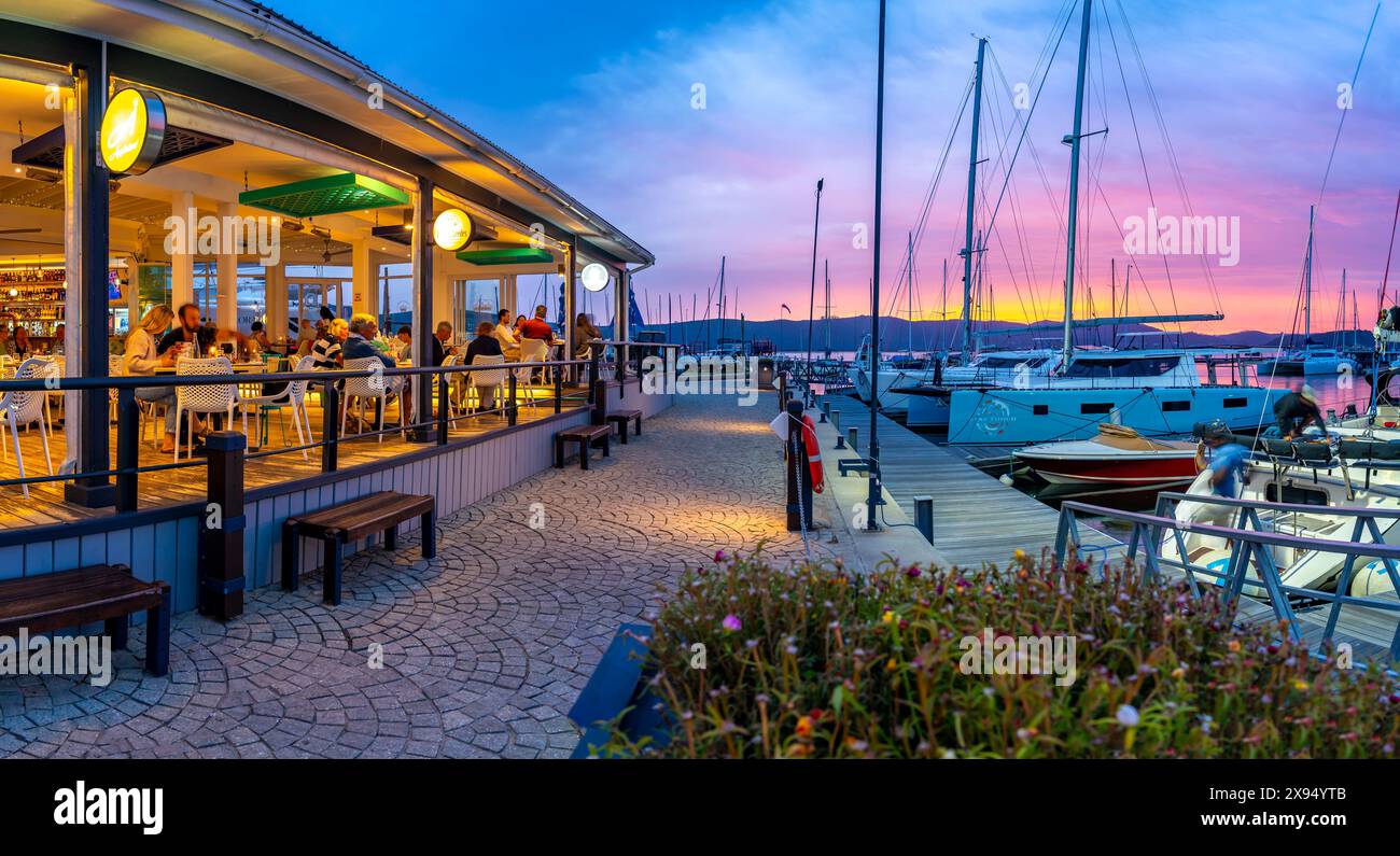 View of golden sunset, boats and restaurants at Knysna Waterfront, Knysna, Western Cape Province