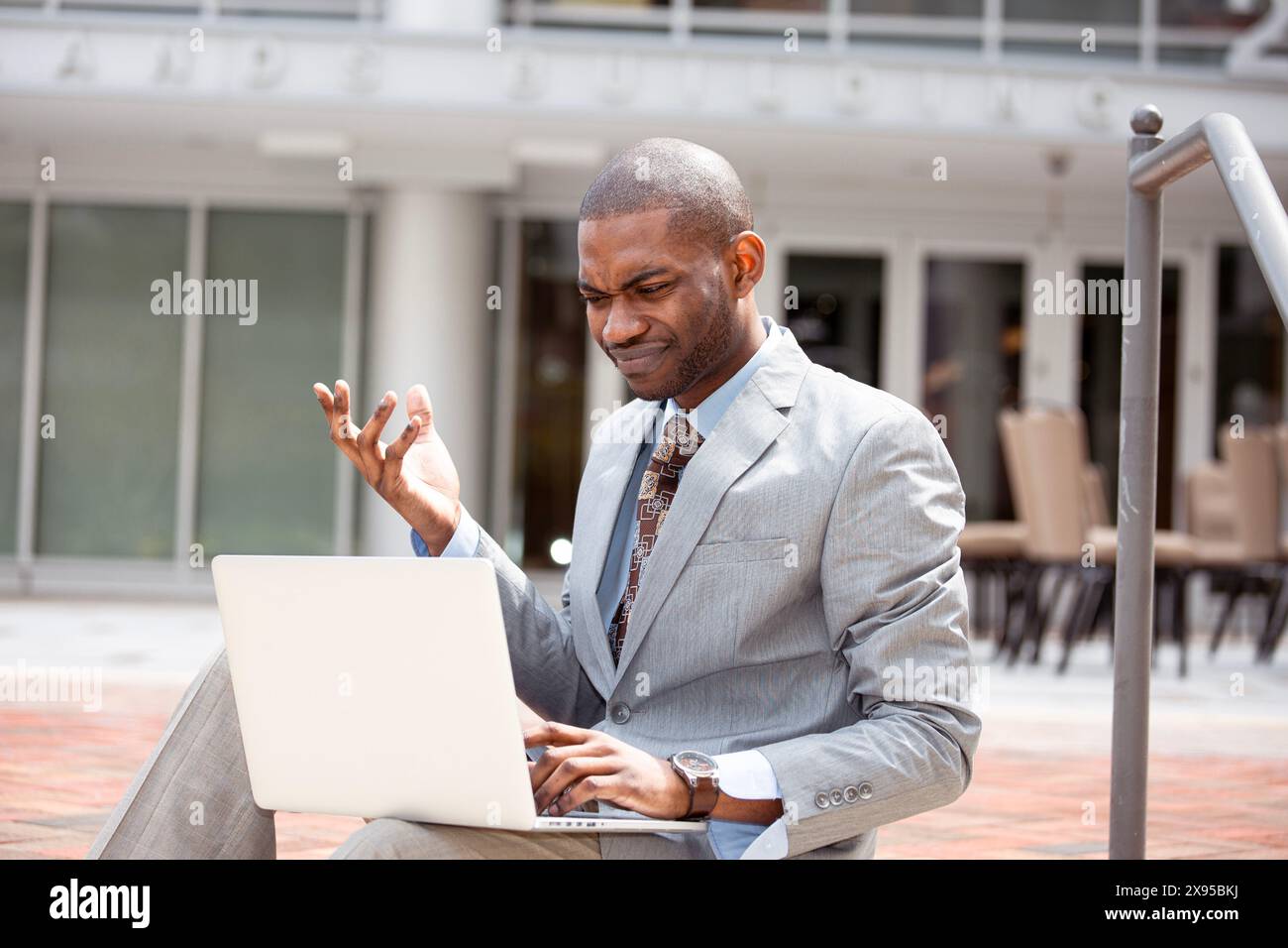 Frustrated business man reading bad news on laptop computer Stock Photo