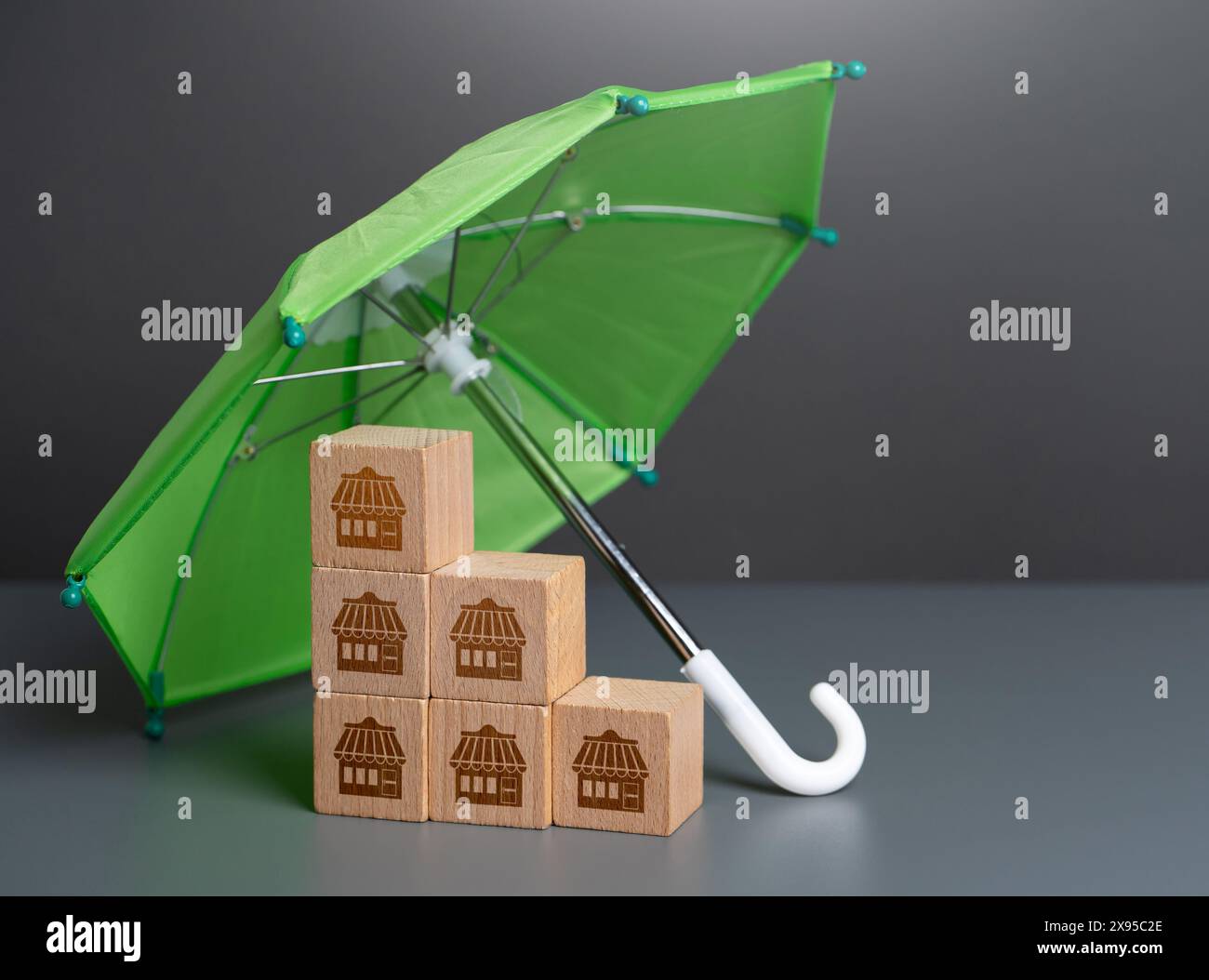 Business under the protection of an umbrella. Obtaining appropriate insurance coverage. Protect your physical assets, data, and intellectual property. Stock Photo