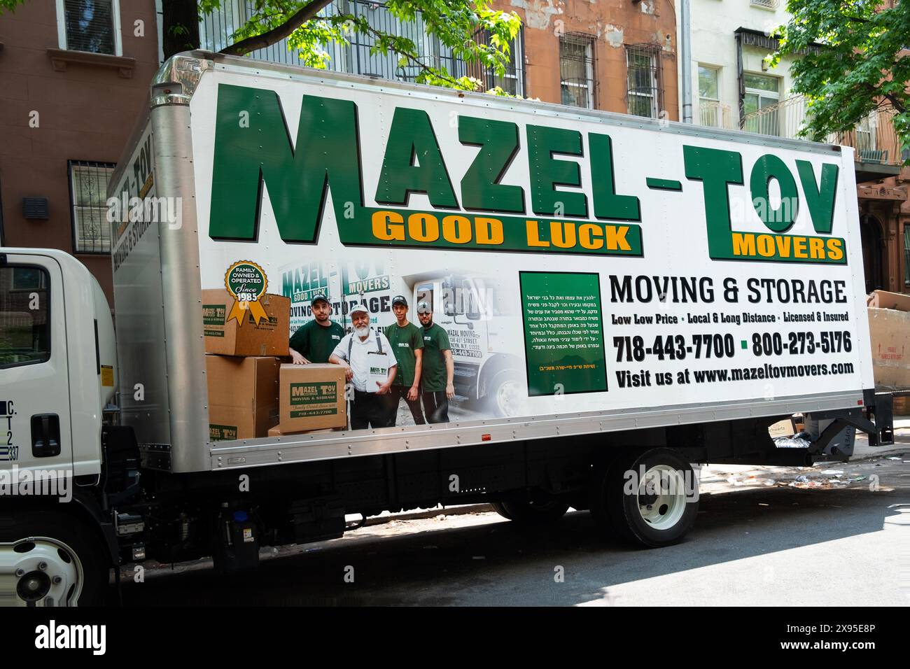 The Mazel Tov Movers truck, an orthodox Jewish business here parked in an orthodox Jewish neighborhood. In Williamsburg, Brooklyn, New York. Stock Photo