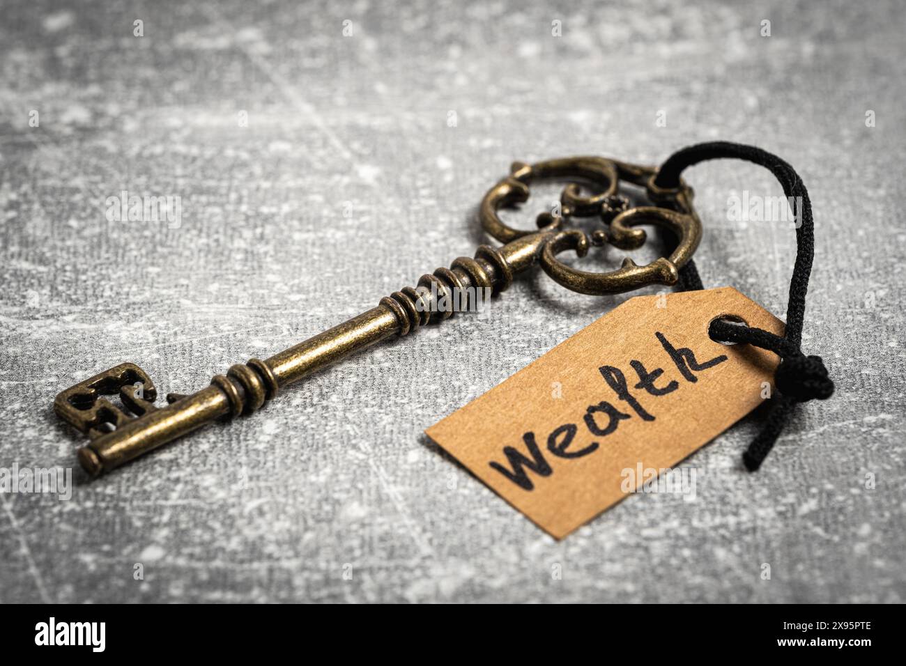 Key Inscription Vintage key with tag and inscription wealth. Concept is key to success ...