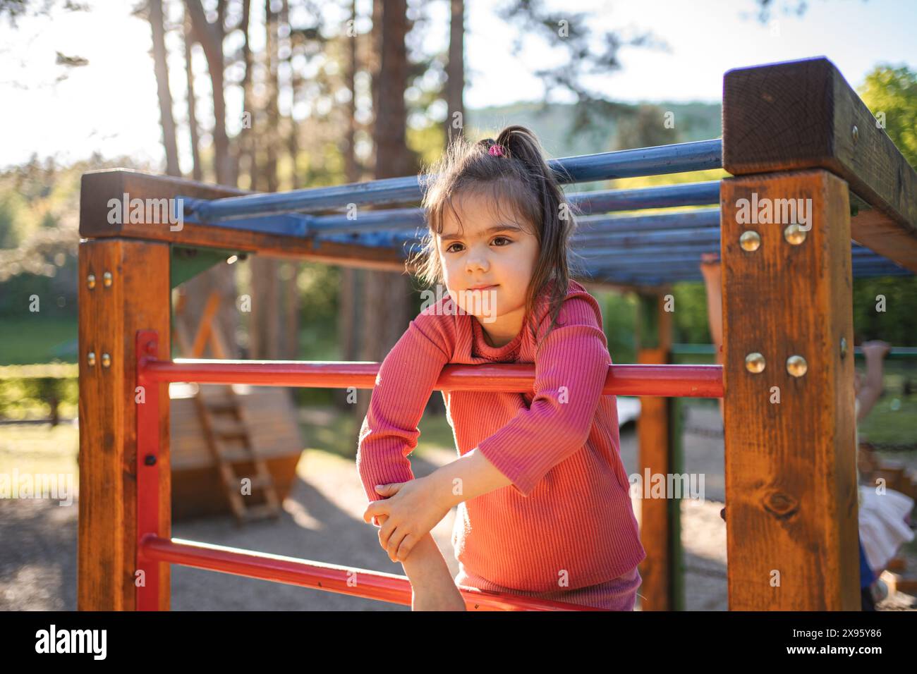 Active cute little girl on the playground Stock Photo - Alamy