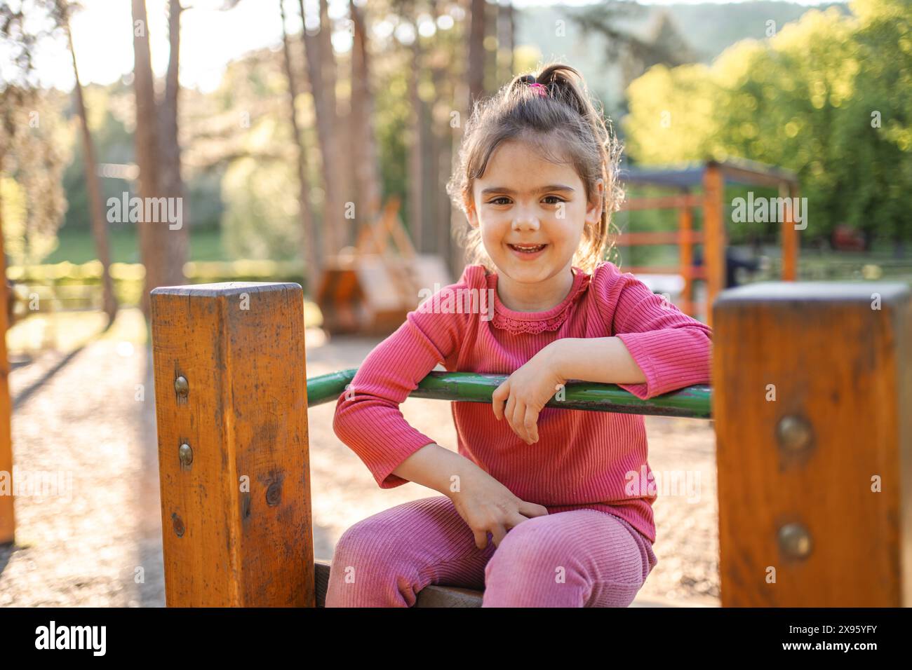 Active cute little girl on the playground Stock Photo - Alamy