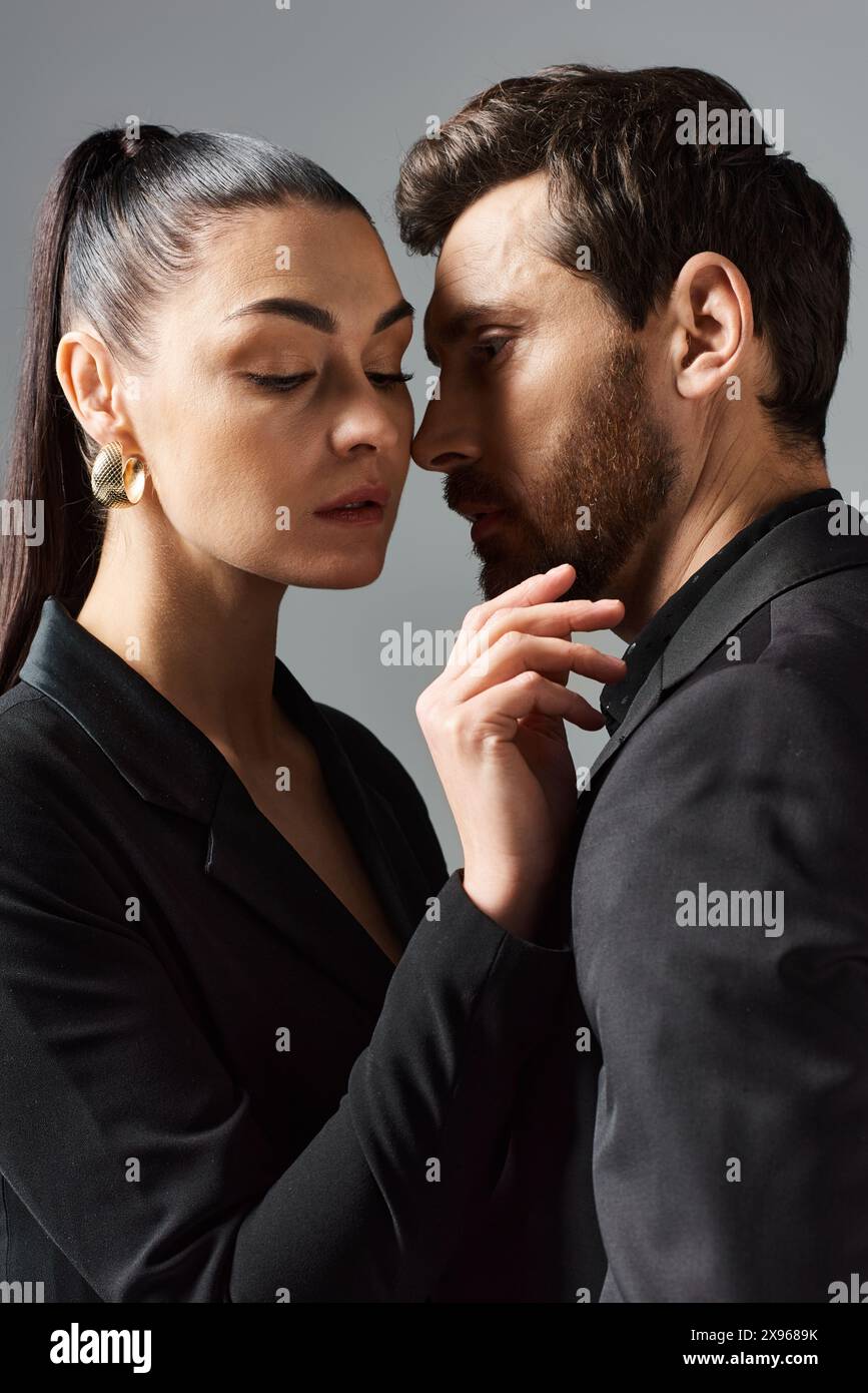 A man and a woman in elegant attire standing side by side in a loving ...