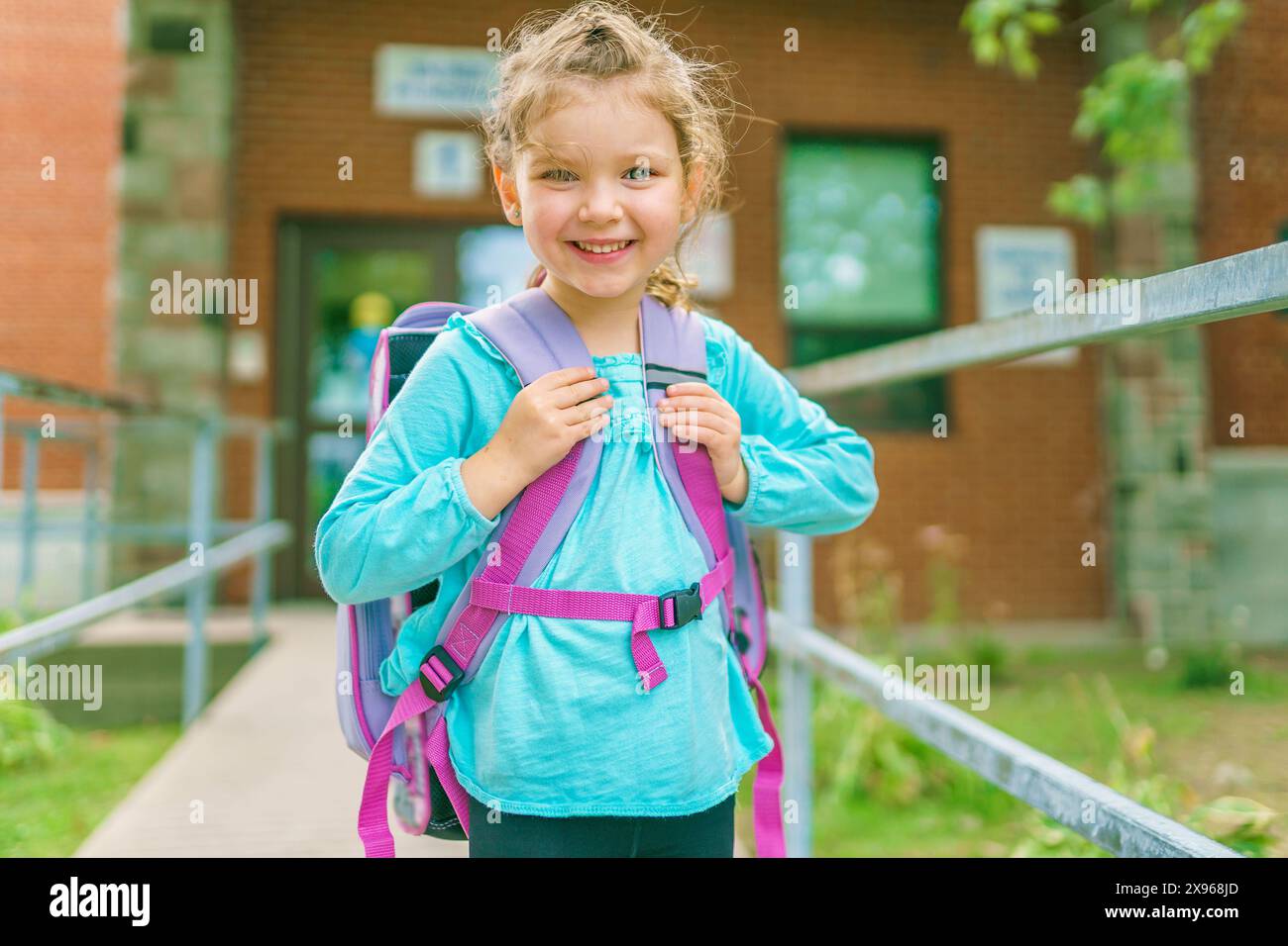 girl with backpack is ready for her first day of school. Stock Photo