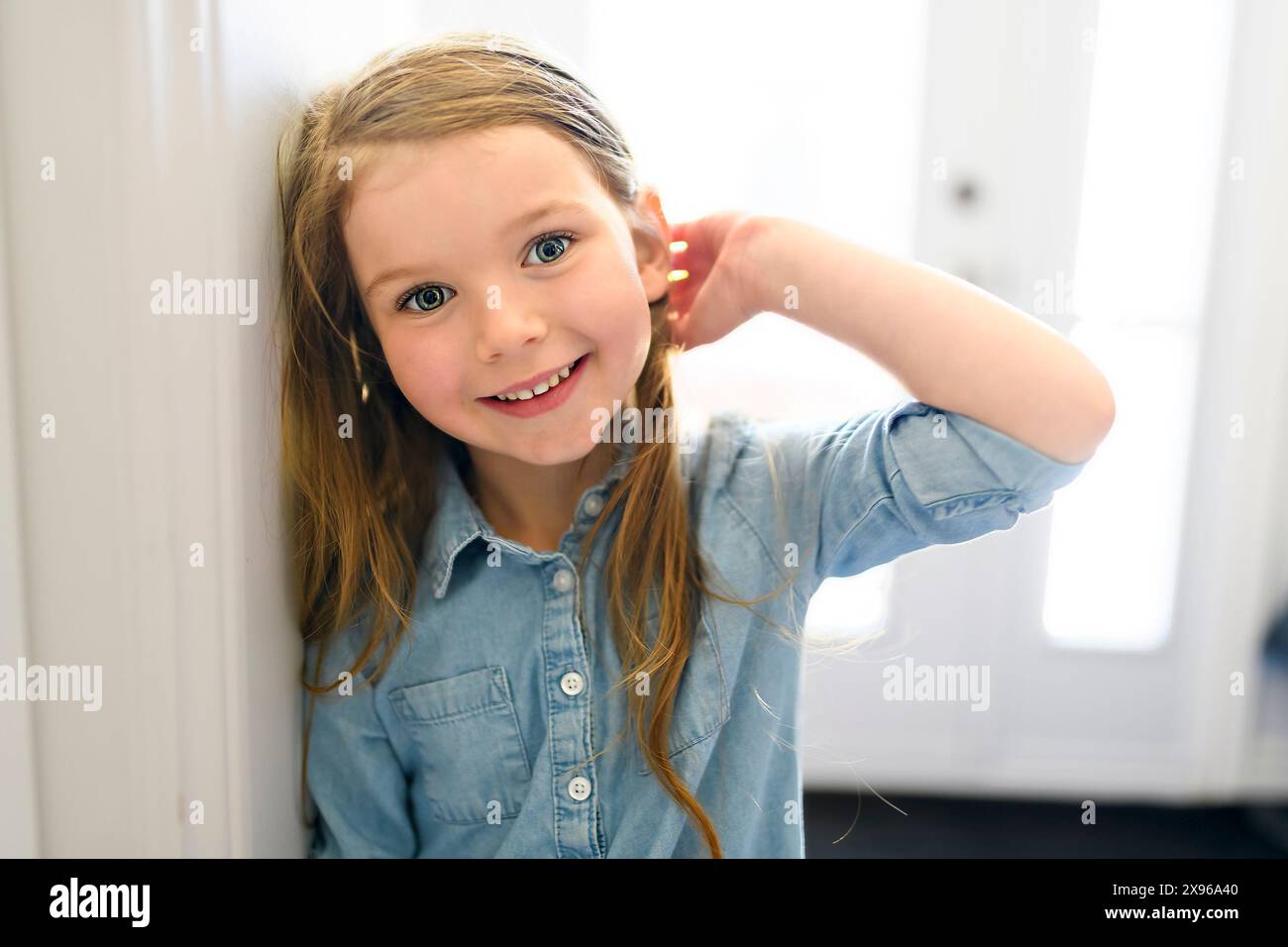 girl smiling in front of the home door Stock Photo - Alamy