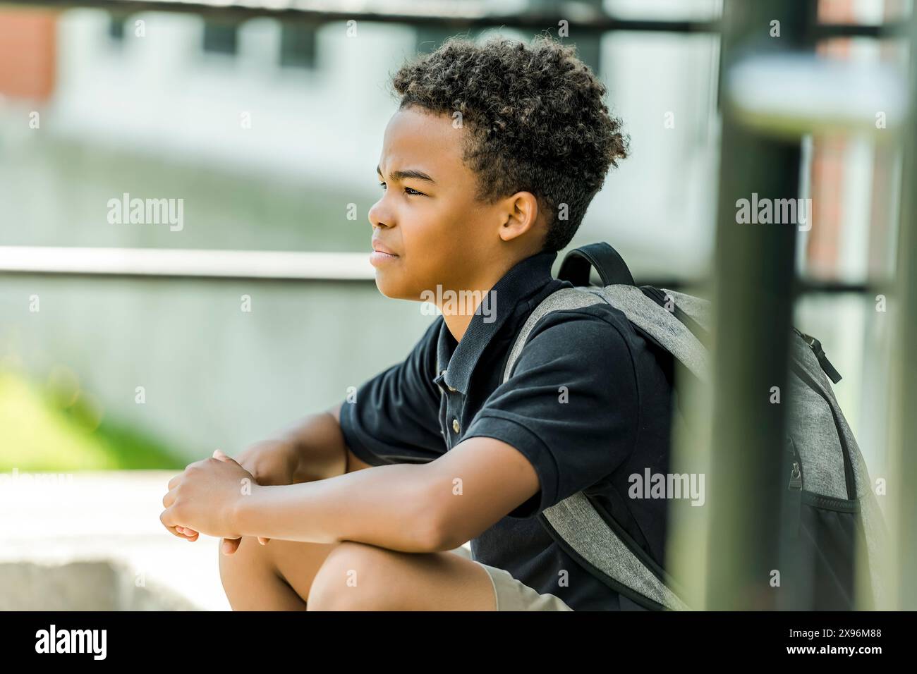 African american school boy with backpack outside Stock Photo - Alamy