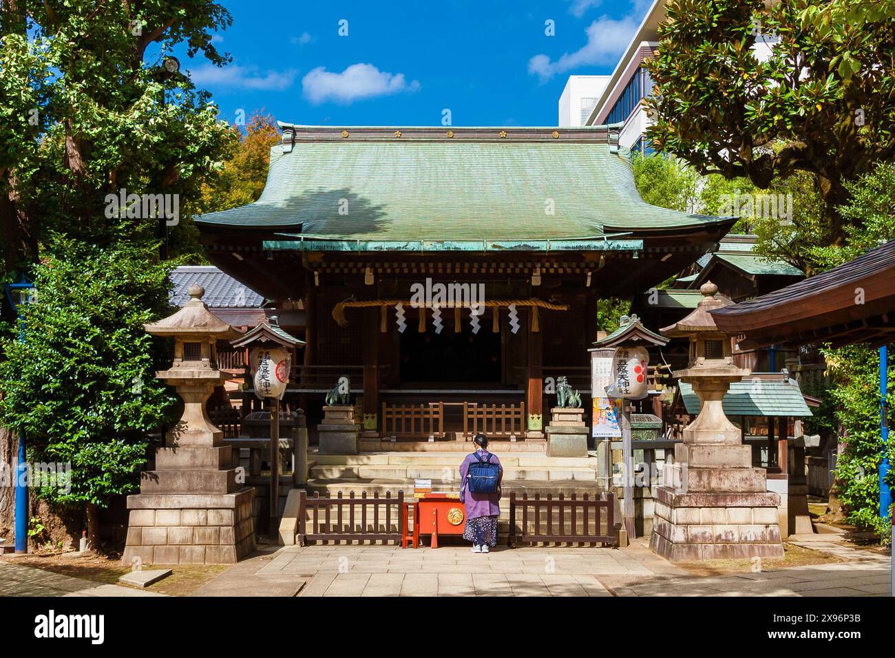Religion and spirituality in Japan. Praying in front of Gojoten Shrine in Ueno Park Stock Photo