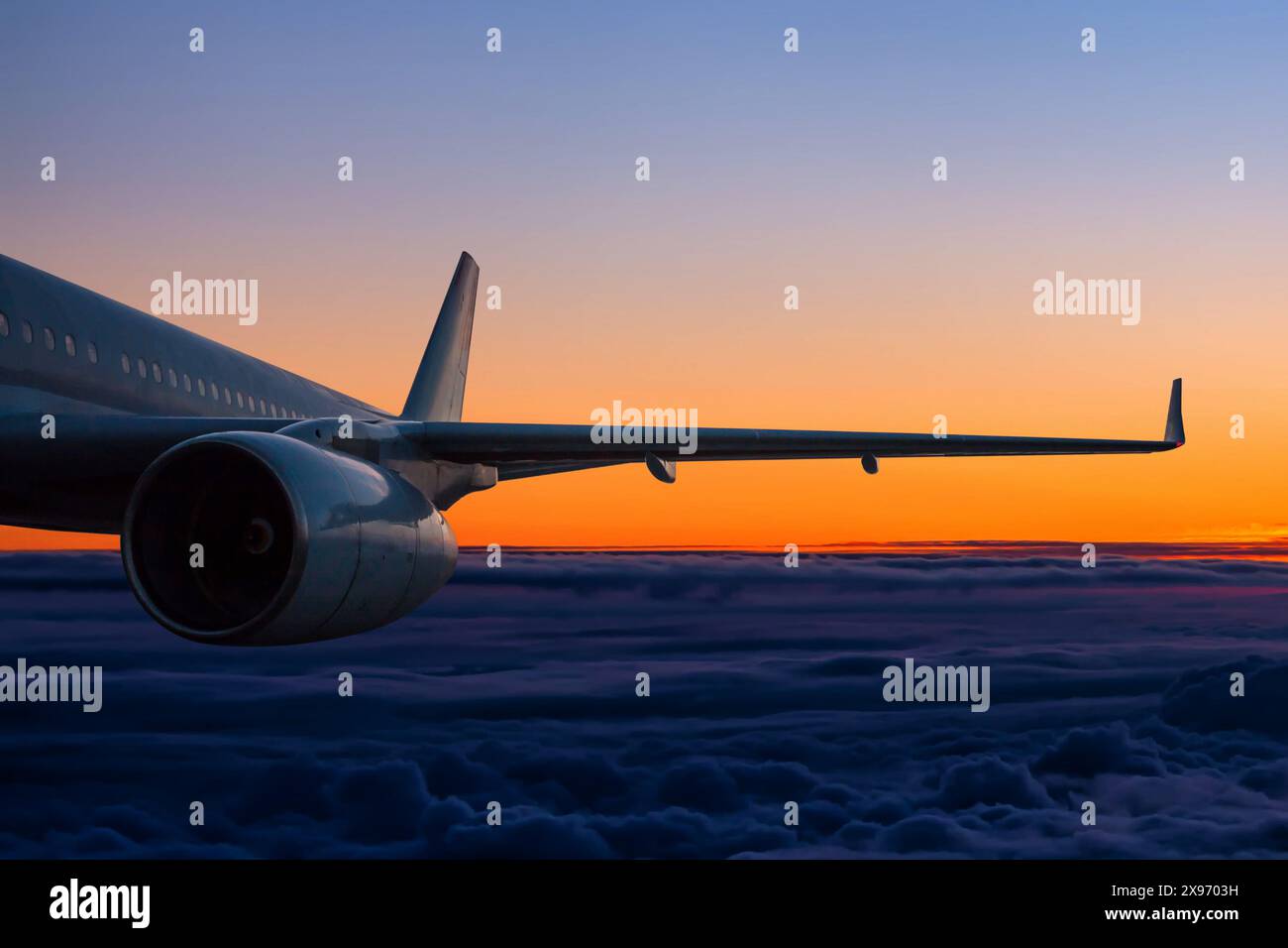 Passenger airplane flies in the sunset sky Stock Photo - Alamy