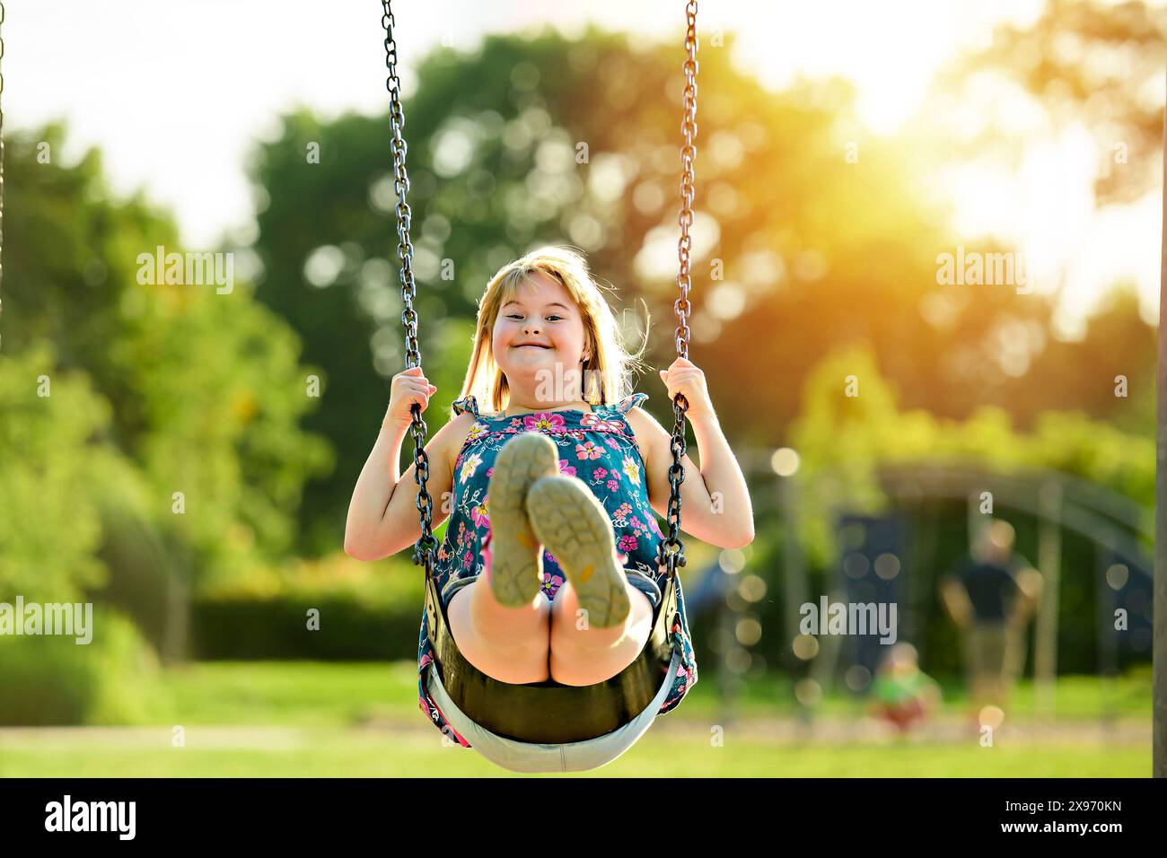 portrait of child girl having fun at the playground swing Stock Photo ...