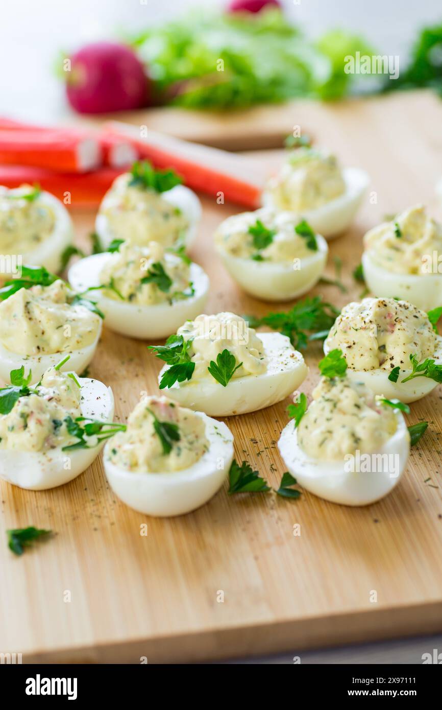 stuffed eggs, deviled eggs on a wooden table . Stock Photo