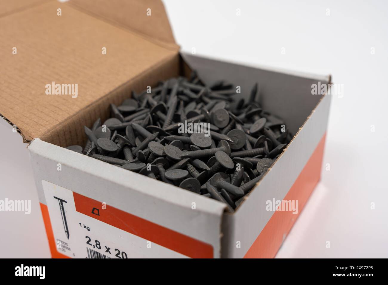 A box of nails for roofing. Roof nails isolated on white background. Stock Photo