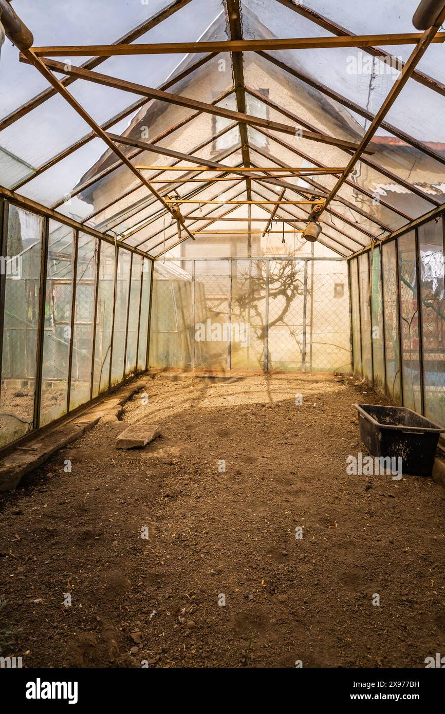 Inside of empty greenhouse, preparing soil in hothouse for sowing Stock Photo