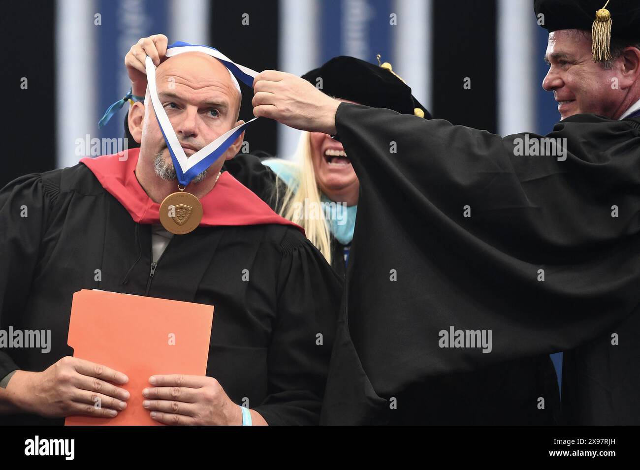New York, USA. 29th May, 2024. Senator John Fetterman (D-PA) receives the Presidential Medallion for Distinguished Heroes of Israel during the commencement ceremony for 2024 Yeshiva University graduating class, at the USTA Billie Jean King National Tennis Center's Louse Armstrong Stadium, Flushing Meadow-Corona Park, Queens, NY, May 29, 2024. (Photo by Anthony Behar/Sipa USA) Credit: Sipa USA/Alamy Live News Stock Photo