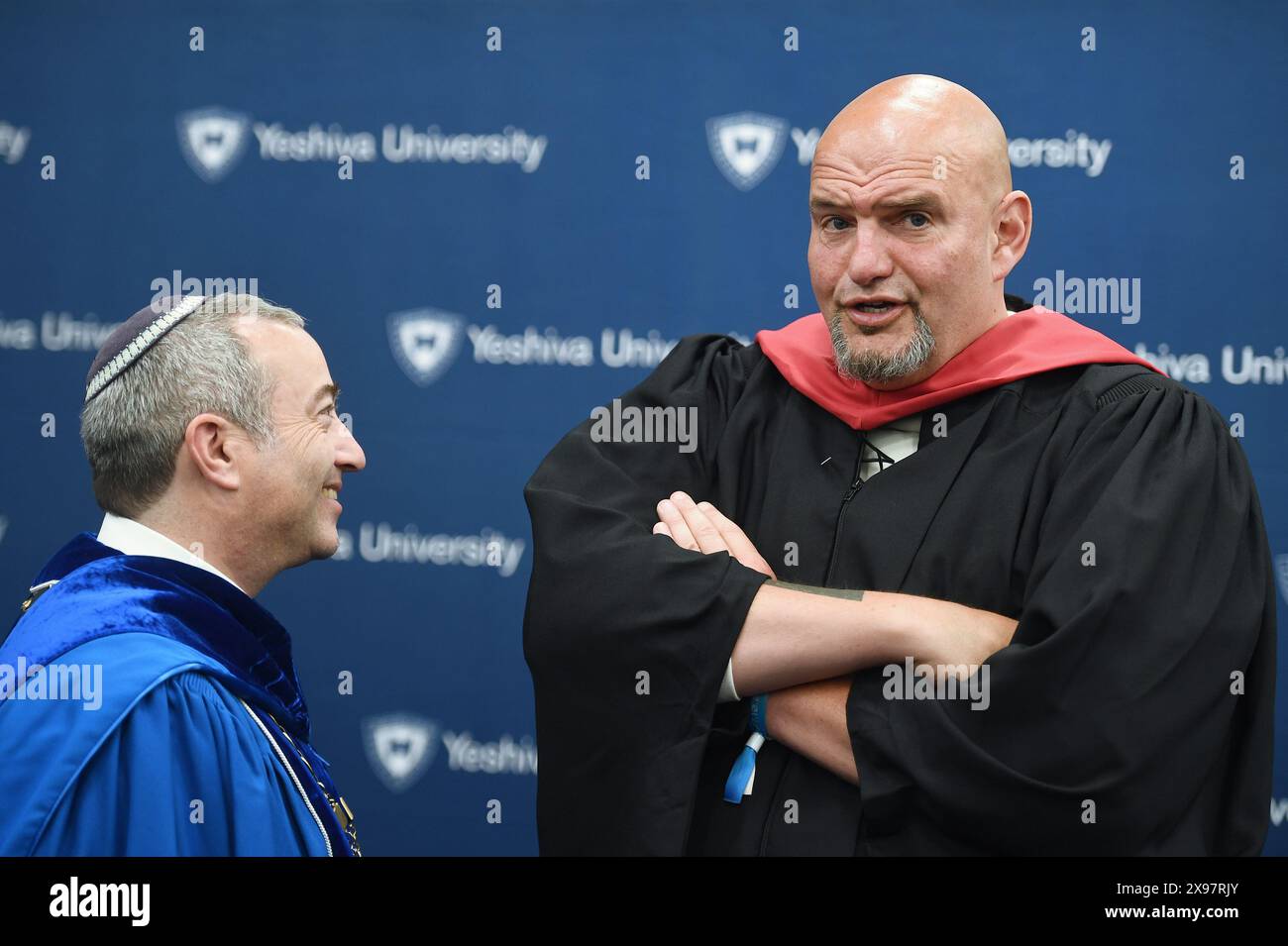 New York, USA. 29th May, 2024. Speaking with Rabbi Dr. Ari Herman (l), President of Yeshiva University, Senator John Fetterman (D-PA) attends the commencement ceremony for 2024 Yeshiva University graduating class, at the USTA Billie Jean King National Tennis Center's Louse Armstrong Stadium, Flushing Meadow-Corona Park, Queens, NY, May 29, 2024. (Photo by Anthony Behar/Sipa USA) Credit: Sipa USA/Alamy Live News Stock Photo
