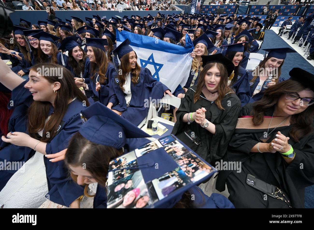 New York, USA. 29th May, 2024. Members of the 2024 graduating class celebrate during Yeshiva University's 93rd Commencement ceremonies at the USTA Billie Jean King National Tennis Center's Louse Armstrong Stadium, Flushing Meadow-Corona Park, Queens, NY, May 29, 2024. (Photo by Anthony Behar/Sipa USA) Credit: Sipa USA/Alamy Live News Stock Photo