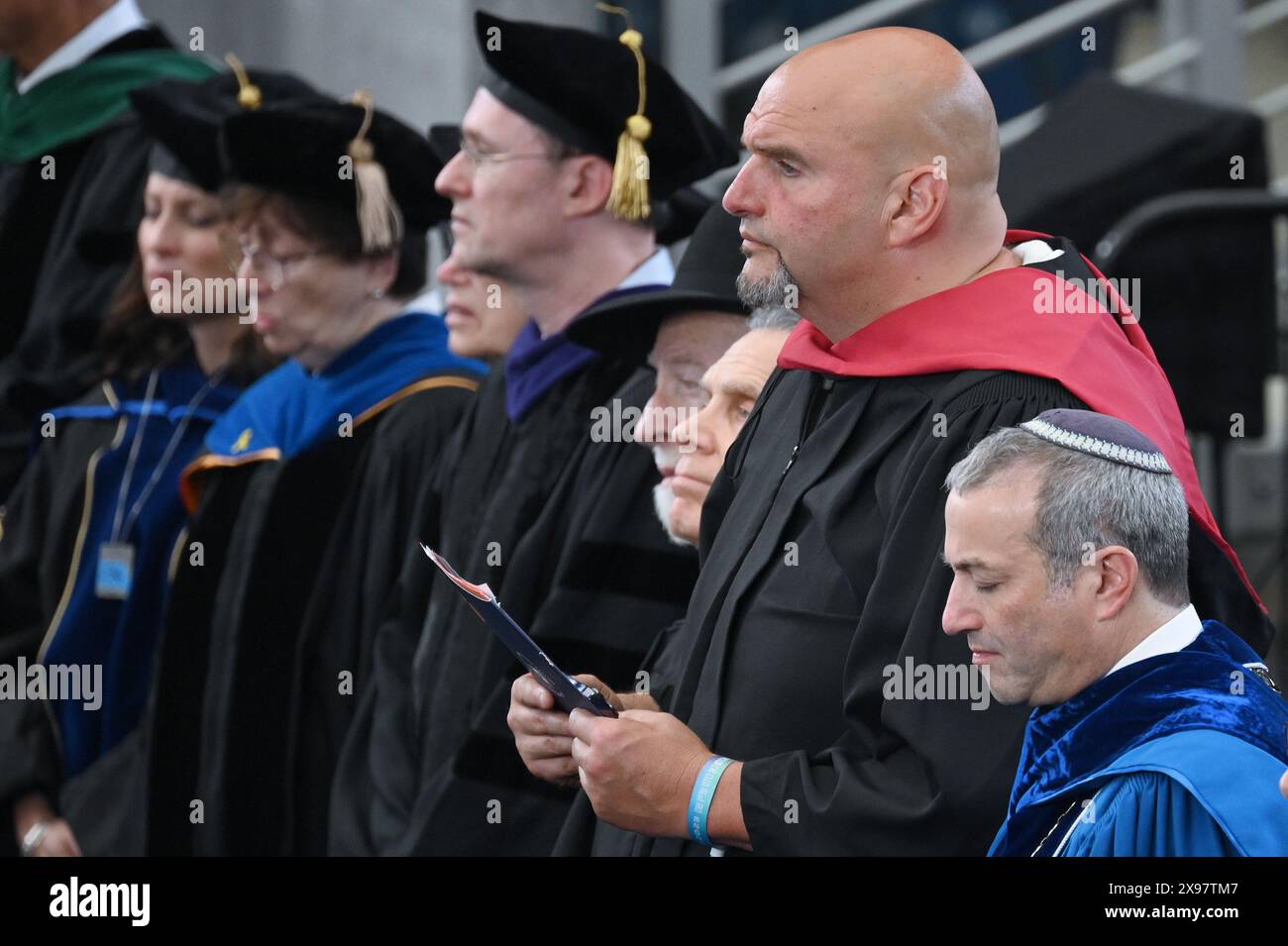 New York, USA. 29th May, 2024. Fetterman (D-PA) stands on stage amongst faculty members and Yeshiva University President Rabbi Dr. Ari Herman during Yeshiva University's 93rd Commencement ceremonies at the USTA Billie Jean King National Tennis Center's Louse Armstrong Stadium, Flushing Meadow-Corona Park, Queens, NY, May 29, 2024. (Photo by Anthony Behar/Sipa USA) Credit: Sipa USA/Alamy Live News Stock Photo
