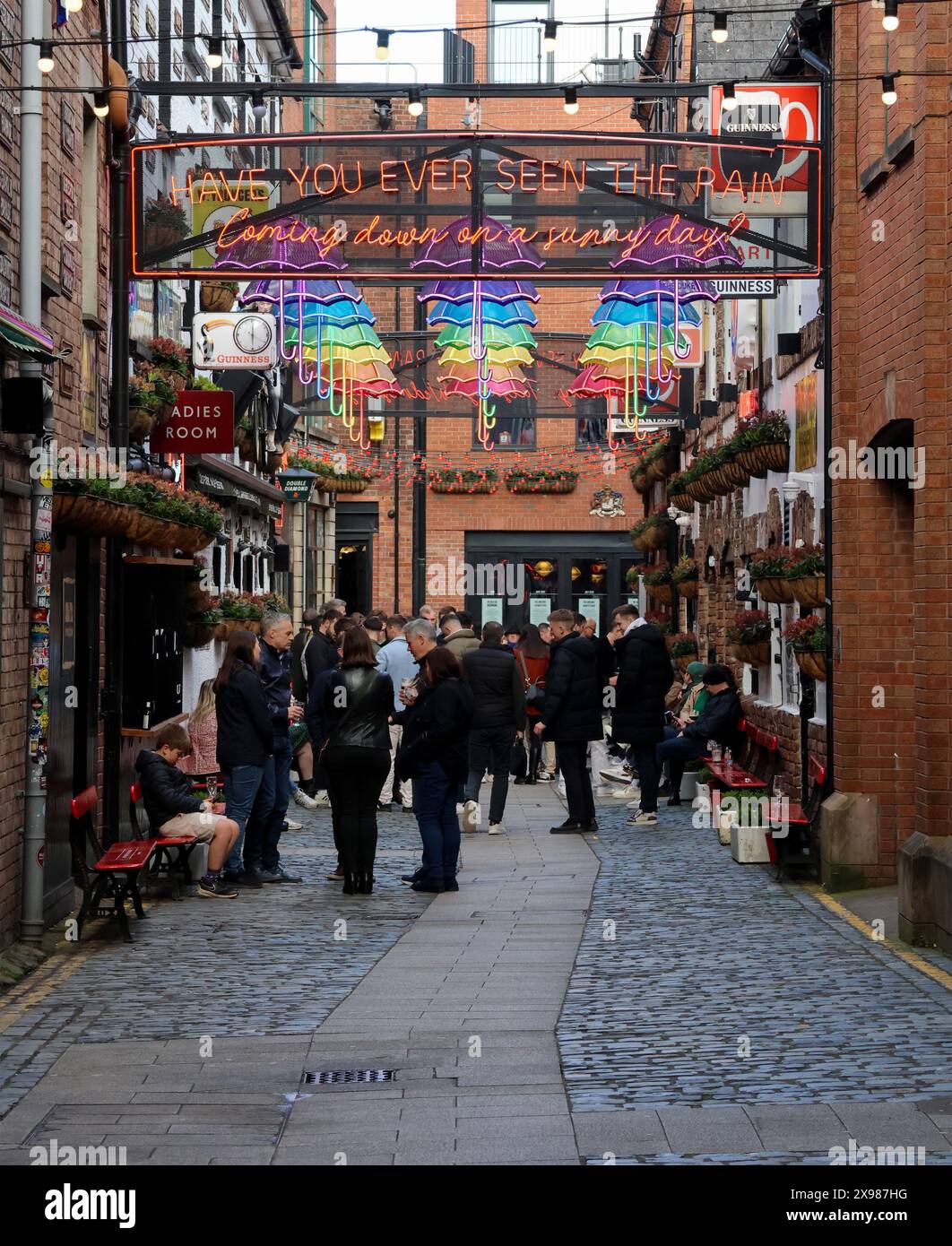 People sitting talking drinking outside popular Belfast bar pub The Duke of York Commercial Court Cathedral Quarter Belfast. Stock Photo