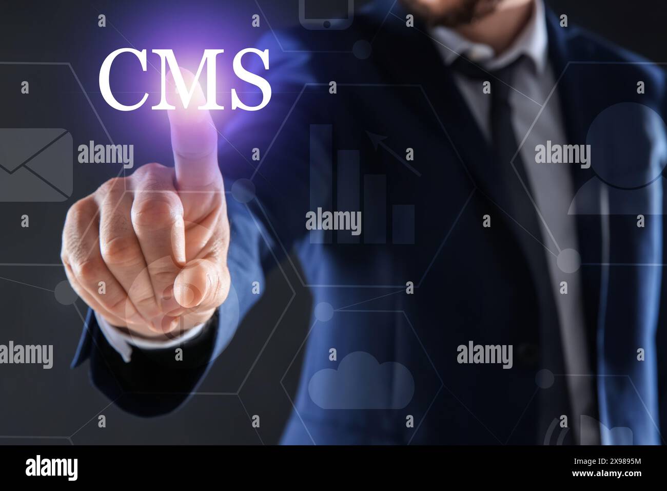 CMS. Man using virtual screen on dark background, closeup Stock Photo
