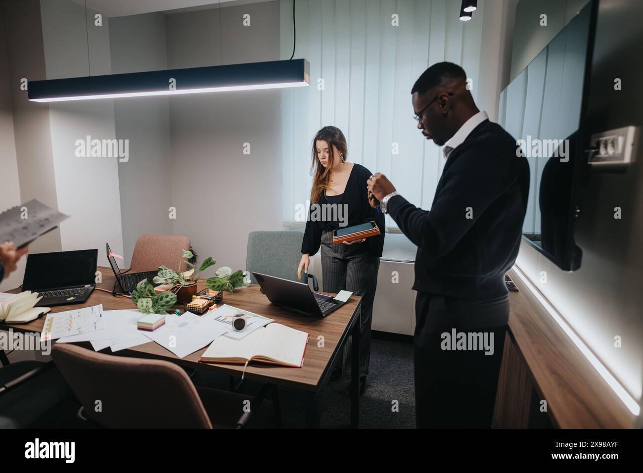 Young multicultural office team collaborating in a modern workspace Stock Photo