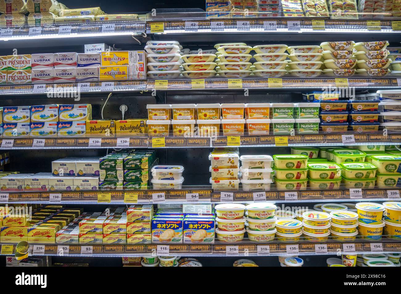 Tubs and packs of butter, margarine and spread on a supermarket shelf ...